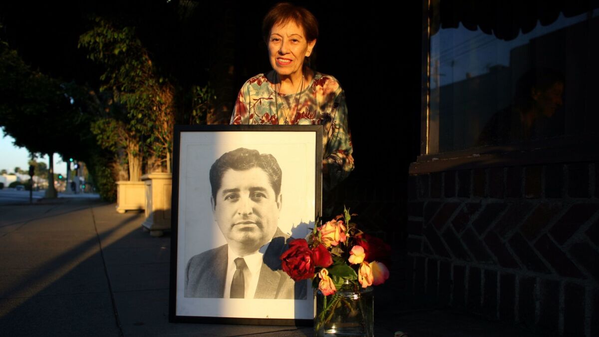 Lucy Casado, the matriarch of Lucy's El Adobe Cafe, in 2008 with a photo of Los Angeles Times columnist Ruben Salazar, who was killed by police in 1970.