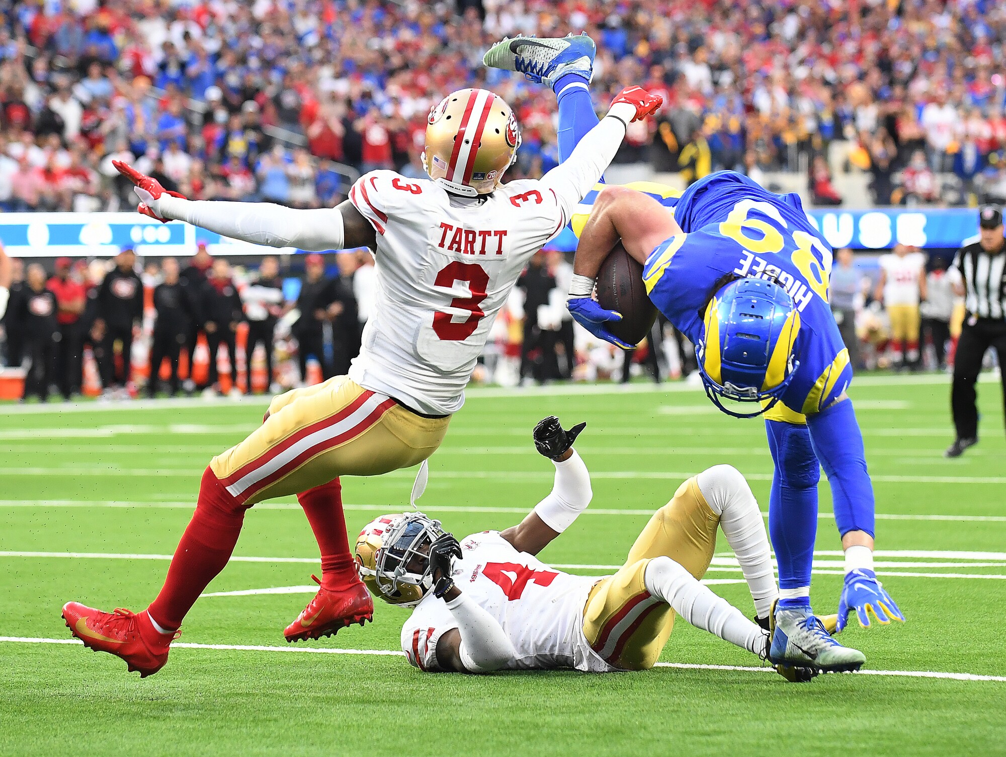 Rams tight end Tyler Higbee is upended by 49ers cornerback Emmanuel Moseley and Jaquiski Tartt.