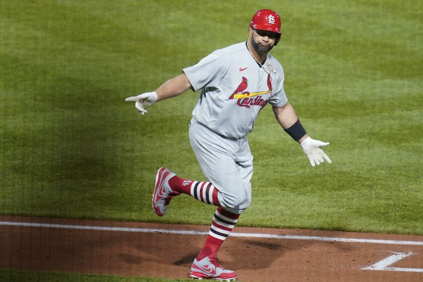 St. Louis Cardinals' Albert Pujols celebrates as he heads to first base after he hit career home run No. 703 during the fifth inning of a baseball game against the Pittsburgh Pirates, Monday, Oct. 3, 2022, in Pittsburgh. (AP Photo/Keith Srakocic)
