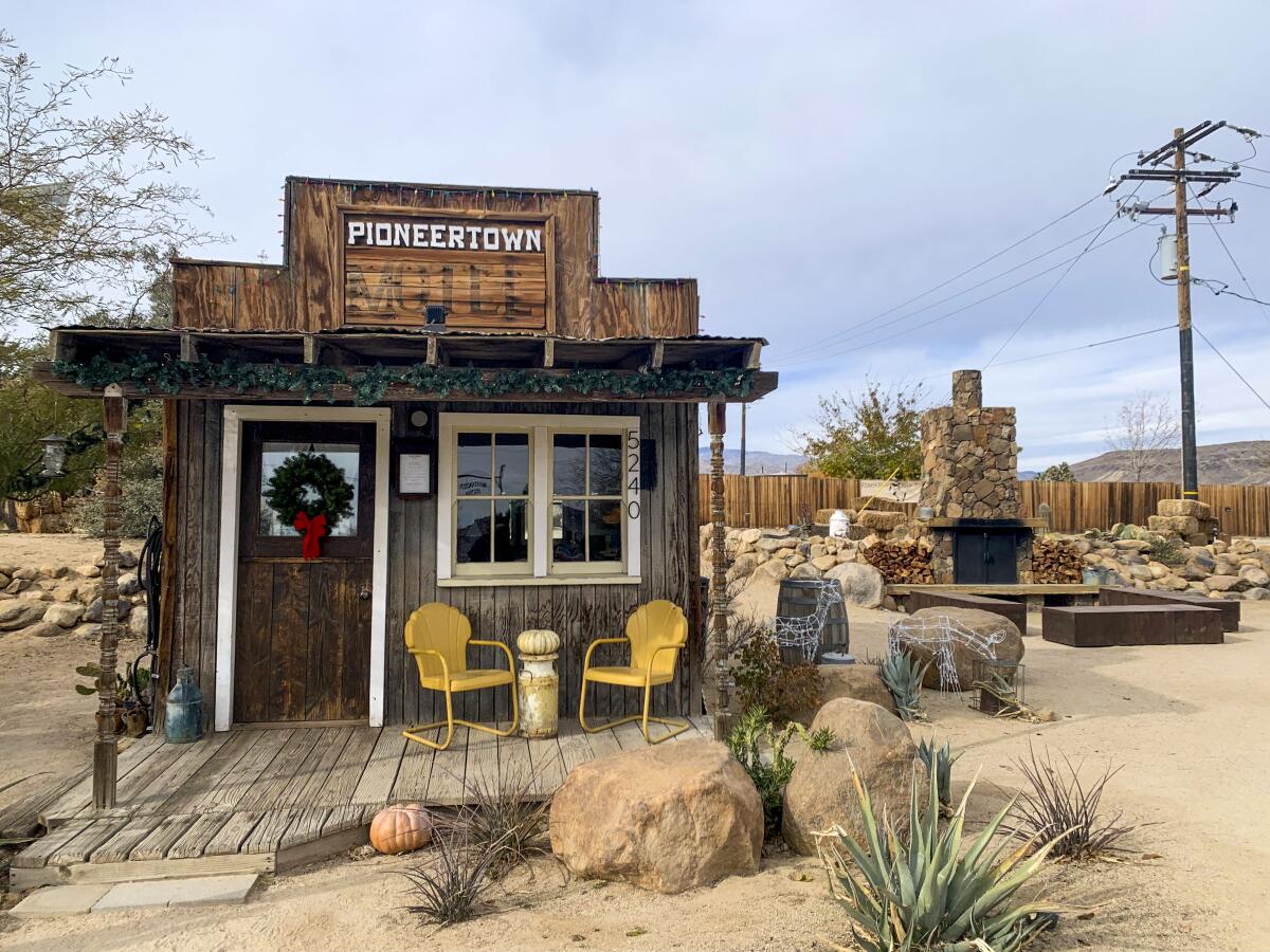 An Old West-style wooden building in a desert setting.