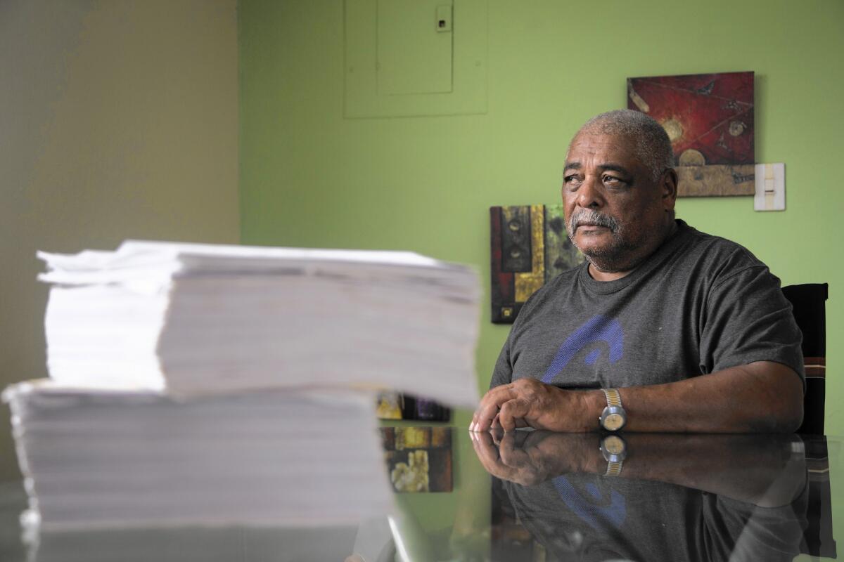 Ivan Figueroa Clausell with paperwork from his disability appeals to the Department of Veterans Affairs.