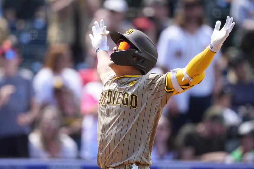 San Diego Padres' Ha-Seong Kim gestures as he crosses home plate after hitting a two-run home run off Colorado Rockies starting pitcher Dakota Hudson in the third inning of a baseball game Thursday, April 25, 2024, in Denver. (AP Photo/David Zalubowski)