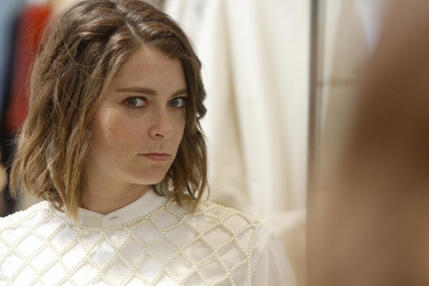 Rachel Bloom tries on a Dries Van Noten open-weave pearl vest over a white Dries Van Noten blouse at Sunset Boulevard boutique Mohawk General Store in Silver Lake.