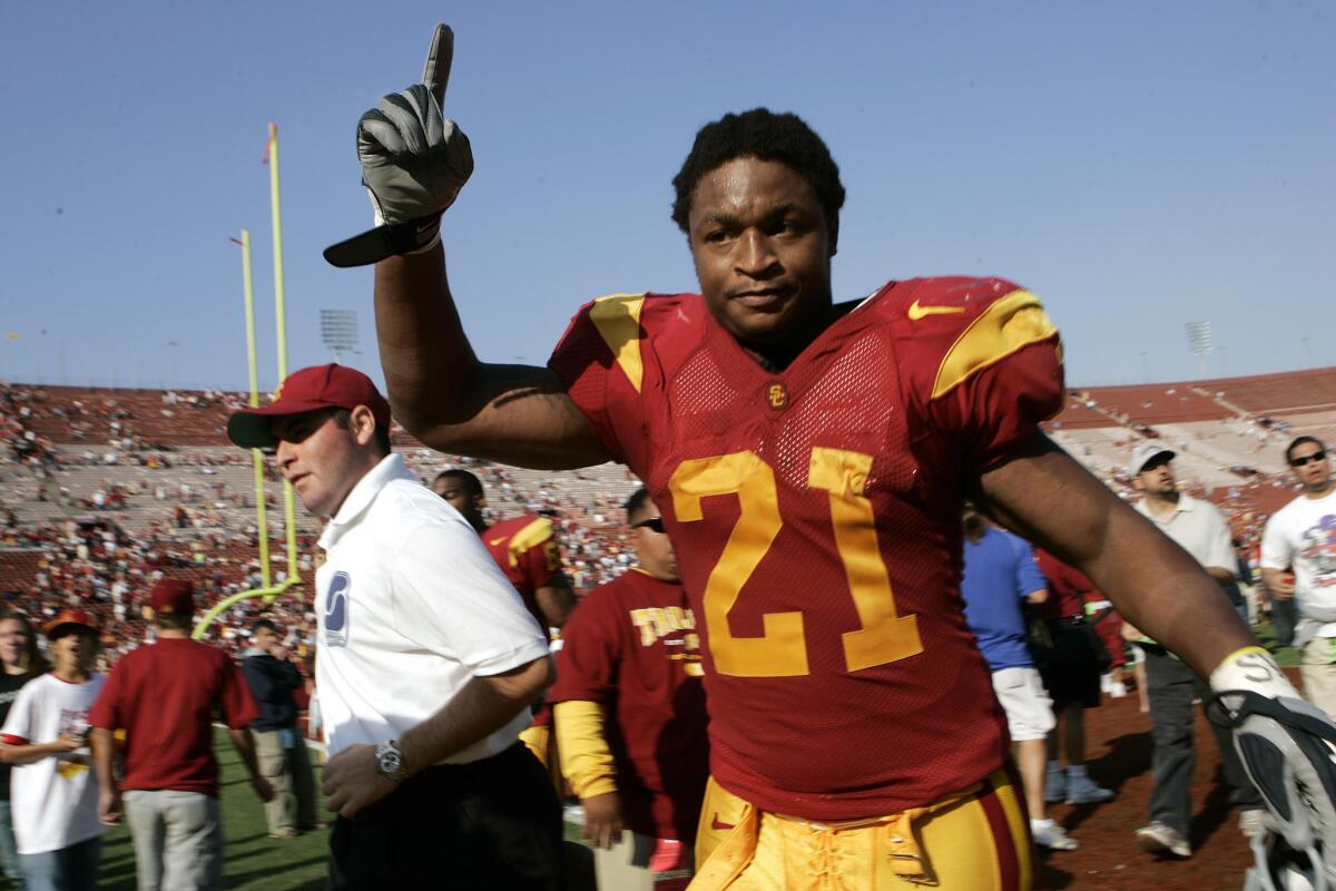 USC tailback LenDale White signals to fans after a Trojans victory in 2005.