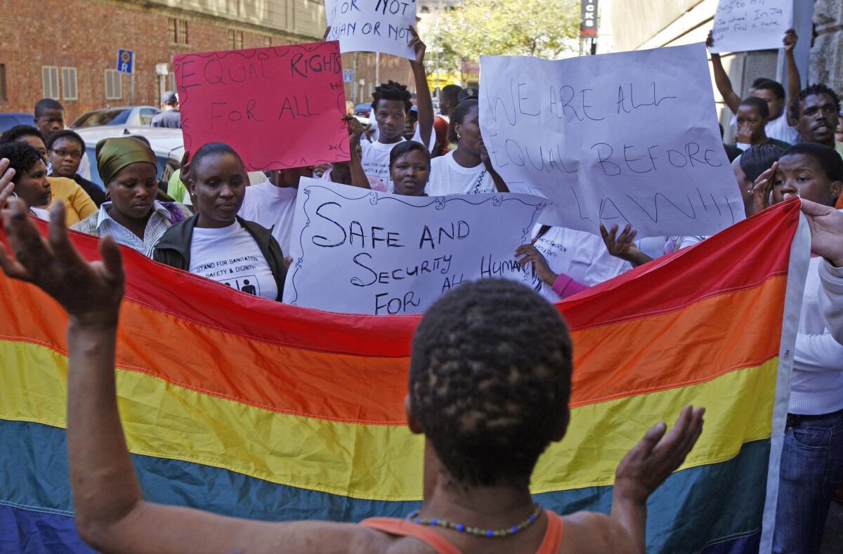 A 2010 photo shows women in South Africa protesting against a sentence of 14 years in prison, with hard labor, given to two men in Malawi under Malawi's anti-gay legislation.
