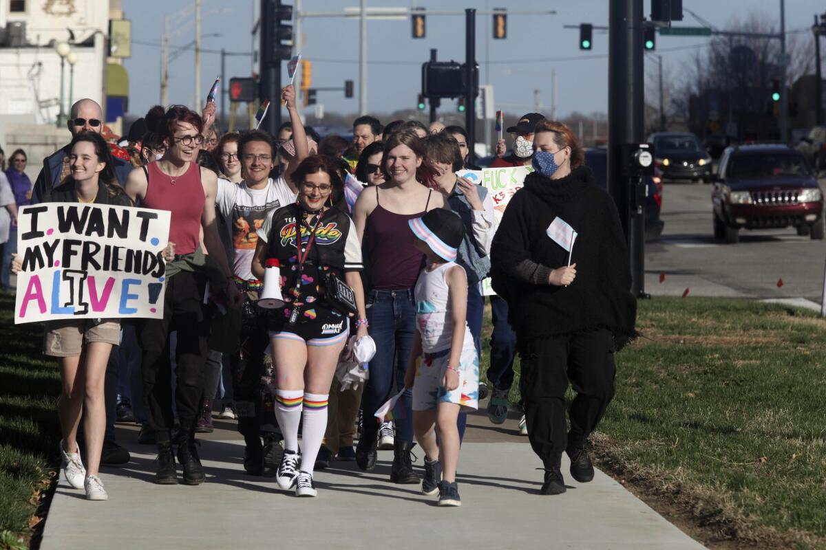 People march around the Kansas Statehouse on the annual Transgender Day of Visibility.