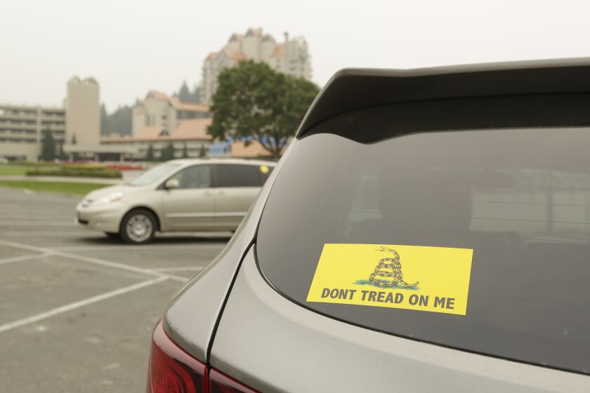 A vehicle with a Gadsden flag sticker is parked in the lot at Independence Point, Friday, Sept. 10, 2021, in Coeur d'Alene, Idaho. Northern Idaho has a long and deep streak of antigovernment activism that is confounding attempts to battle a COVID-19 outbreak.(AP Photo/Young Kwak)