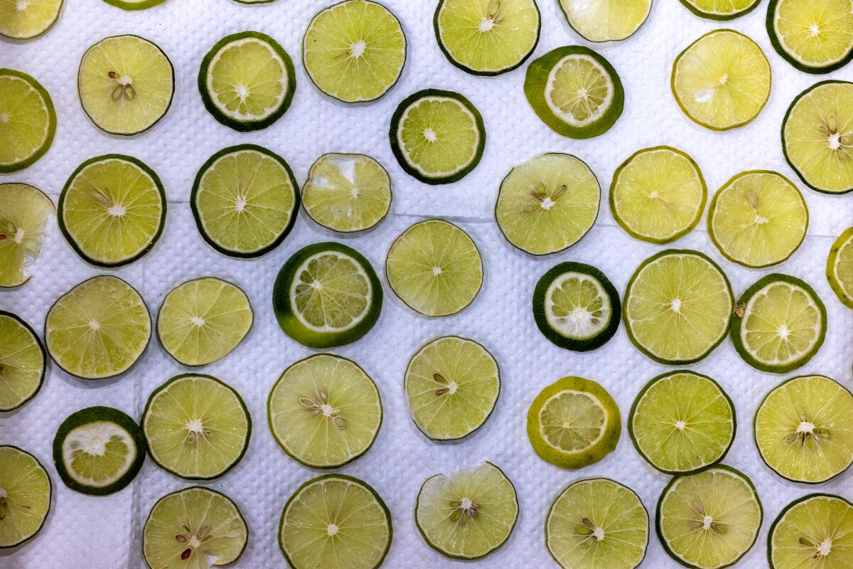 Sliced limes sit out to dry before being used to decorate floats.