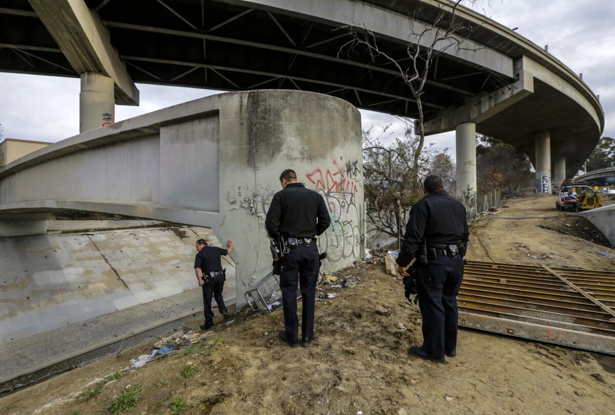 LAPD officers check on homeless encampments along Arroyo Seco.