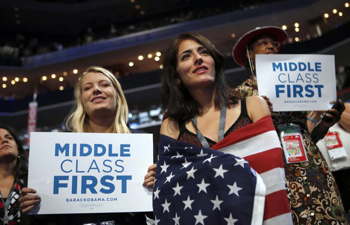 Delegates watch as former President Bill Clinton addresses the Democratic National Convention in Charlotte, N.C. on Sept. 5, 2012.