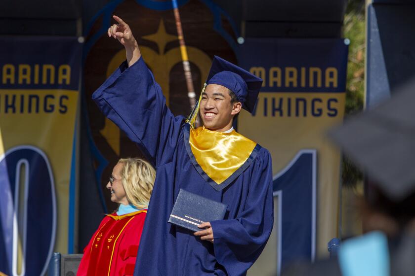 Tyler Nguyen celebrates after receiving his diploma during the 2019 commencement ceremony for Marina High School on Thursday.