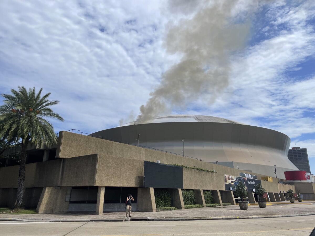 Flames shoot up side of New Orleans Saints' Superdome, put out in