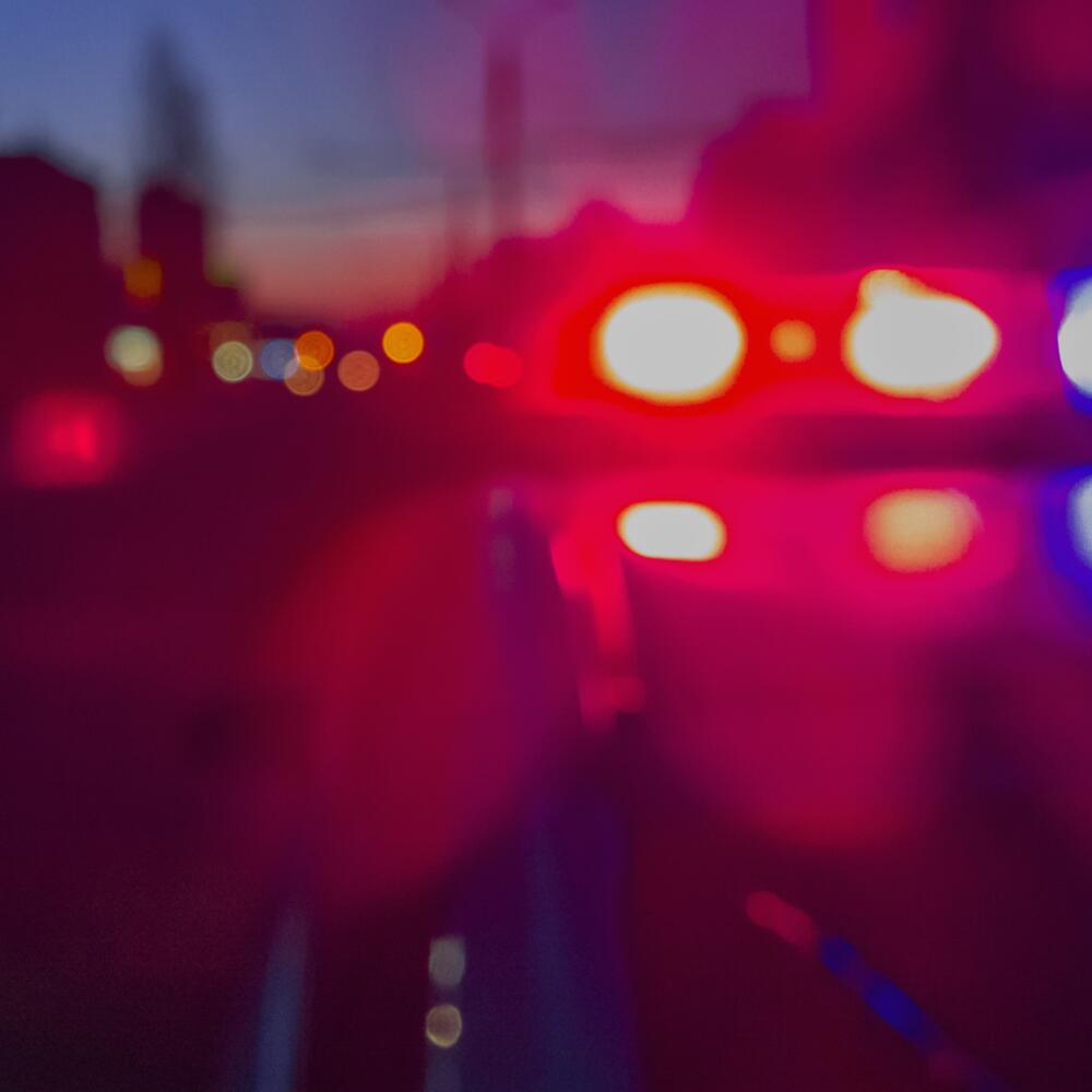Abstract blurry image of red and blue lights of police car in night time. 