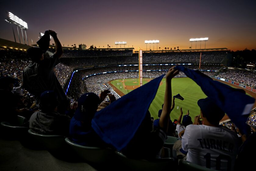 LOS ANGELES, CA - OCTOBER 25: Fans wave towels during game two of the 2017 World Series between the Houston Astros and the Los Angeles Dodgers at Dodger Stadium on October 25, 2017 in Los Angeles, California. (Photo by Sean M. Haffey/Getty Images)