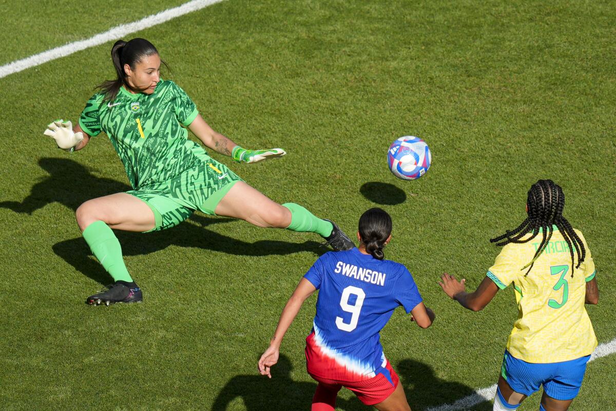 Brazil's goalkeeper Lorena, left, fails to stop a shot by U.S. forward Mallory Swanson during Team USA's win Saturday.