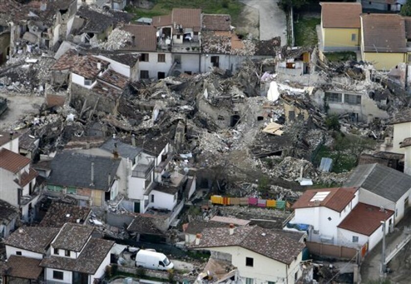 Colored sheets are seen hanging on a clothesline in this aerial view of the village of Onna, a day after a powerful earthquake struck the Abruzzo region in central Italy, on Tuesday, April 7, 2009. The death toll from Italy's worst earthquake in three decades jumped to 207 as bodies were recovered and identified. Fifteen people remained unaccounted for. (AP Photo/Alessandra Tarantino)