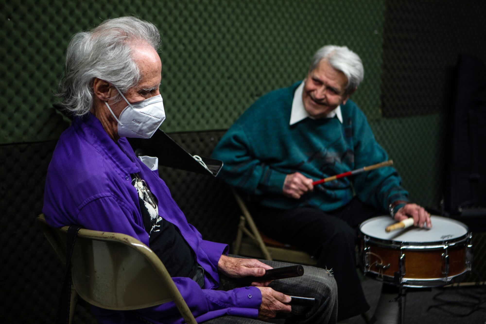 John Densmore, left, and jazz drummer Steve Hideg, 91, right, play music together