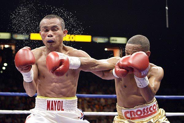 WBO junior flyweight champion Ivan Calderon of Puerto Rico, right, lands a hard right on challenger Rodel Mayol of the Philippines in the third round of their bout Saturday in San Juan. Calderon won by split decision after the fight was stopped in the seventh round because of an accidental head butt.