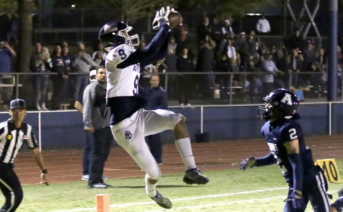 Newport Harbor High's Duke Starnes jumps to catch a touchdown in the second quarter of Friday night's game.