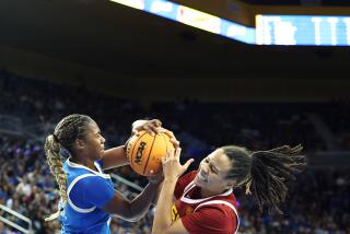 LOS ANGELES-CA-DECEMBER 30, 2023: USC's McKenzie Forbes, right, fights for the ball.