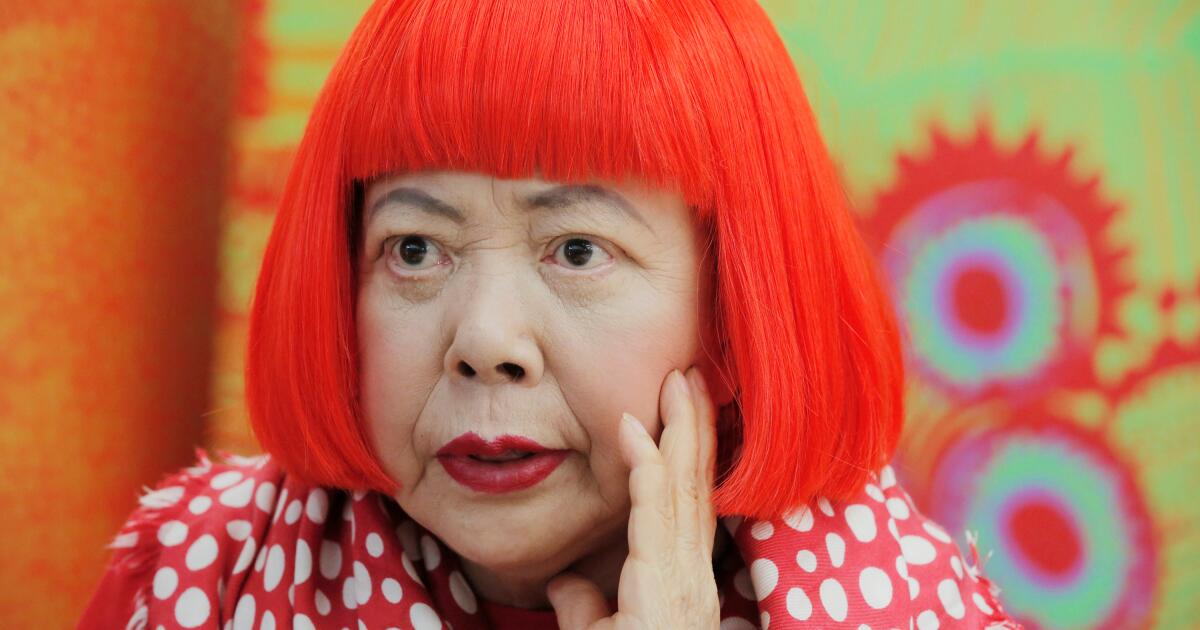 Photo: latimes.com FILE - Japanese avant-garde artist Yayoi Kusama, wearing a bright red wig and a Louis Vuitton polka dot scarf, speaks during