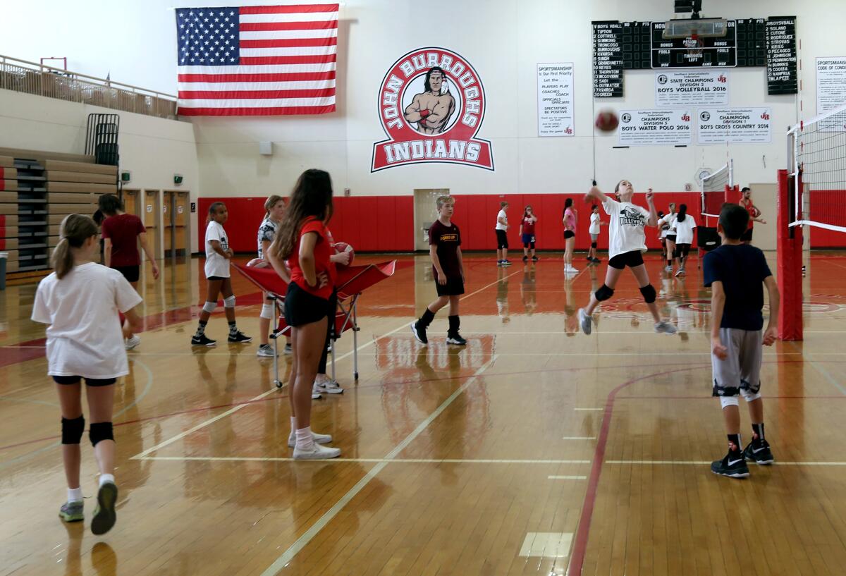 Players at Real's Youth Volleyball Camp participate in drills at a recent session at Burroughs High.