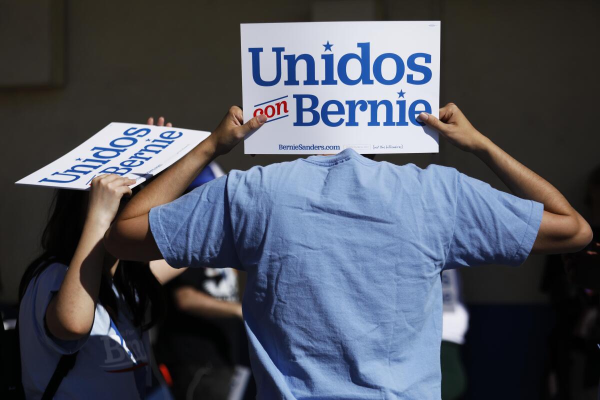 Bernie Sanders supporter James Won, 35, holds up a sign in Spanish that reads, “United with Bernie,” before the Vermont senator’s arrival at Woodrow Wilson Senior High School in East L.A. on Saturday.