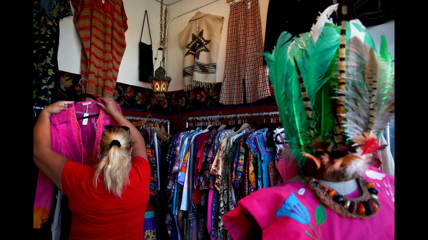 Karen Slease of Gardena searches the racks of Far Outfit for costume possibilities.