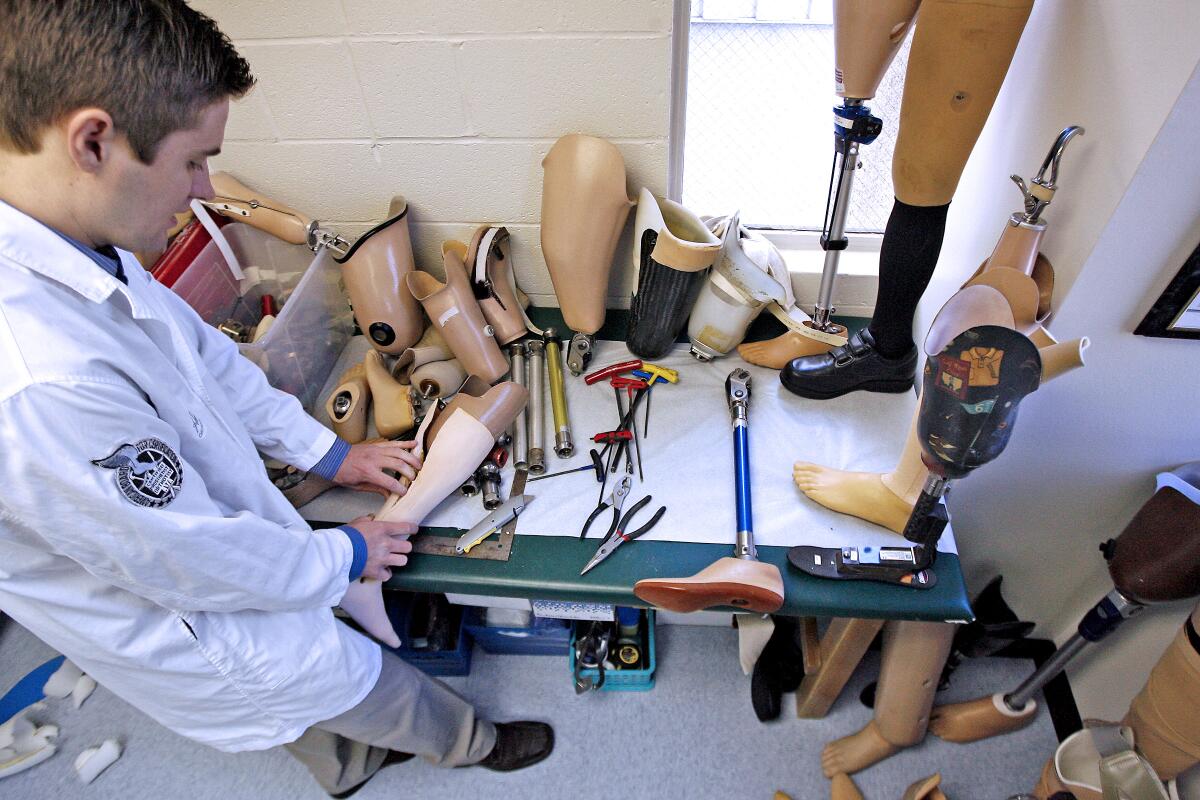 Spencer Doty, an owner and operator of Active Life Inc., works on used prosthetics at their office on Feb. 22, 2010. The company was collecting used prosthetic supplies and parts to send to Haiti to assist victims that have lost limbs as part of their H.E.L.P. campaign, Haiti Earthquake Limb Project.
