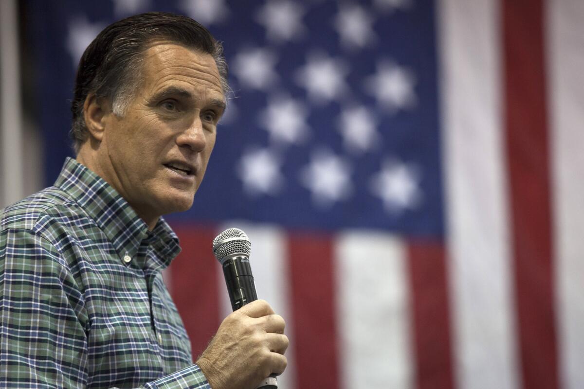 In this file photo, former Massachusetts Gov. Mitt Romney addresses a crowd in Alaska in 2014.