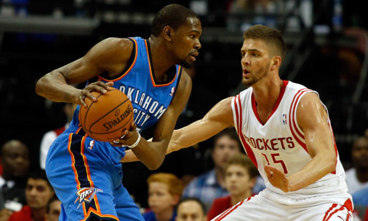 Oklahoma City Thunder forward Kevin Durant, left, tries to drive past Houston Rockets forward Chandler Parsons during an April 4 game. Durant is making a strong case to win the NBA's MVP award this season.