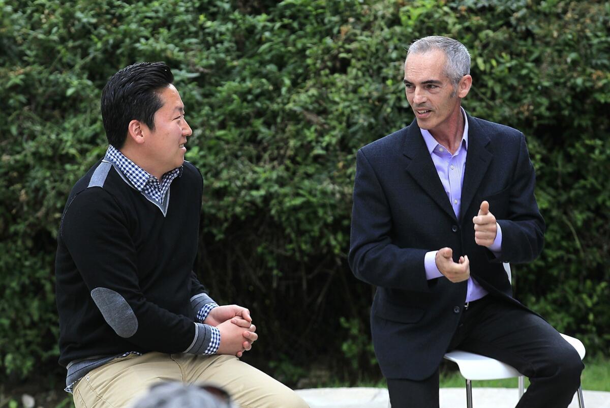 Los Angeles City Council District 13 candidates Mitch O'Farrell and John Choi greet each other before a debate May 5.