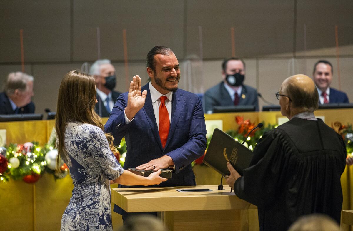 Superior court Judge Steven Bromberg administers the oath of office to Noah Blom.