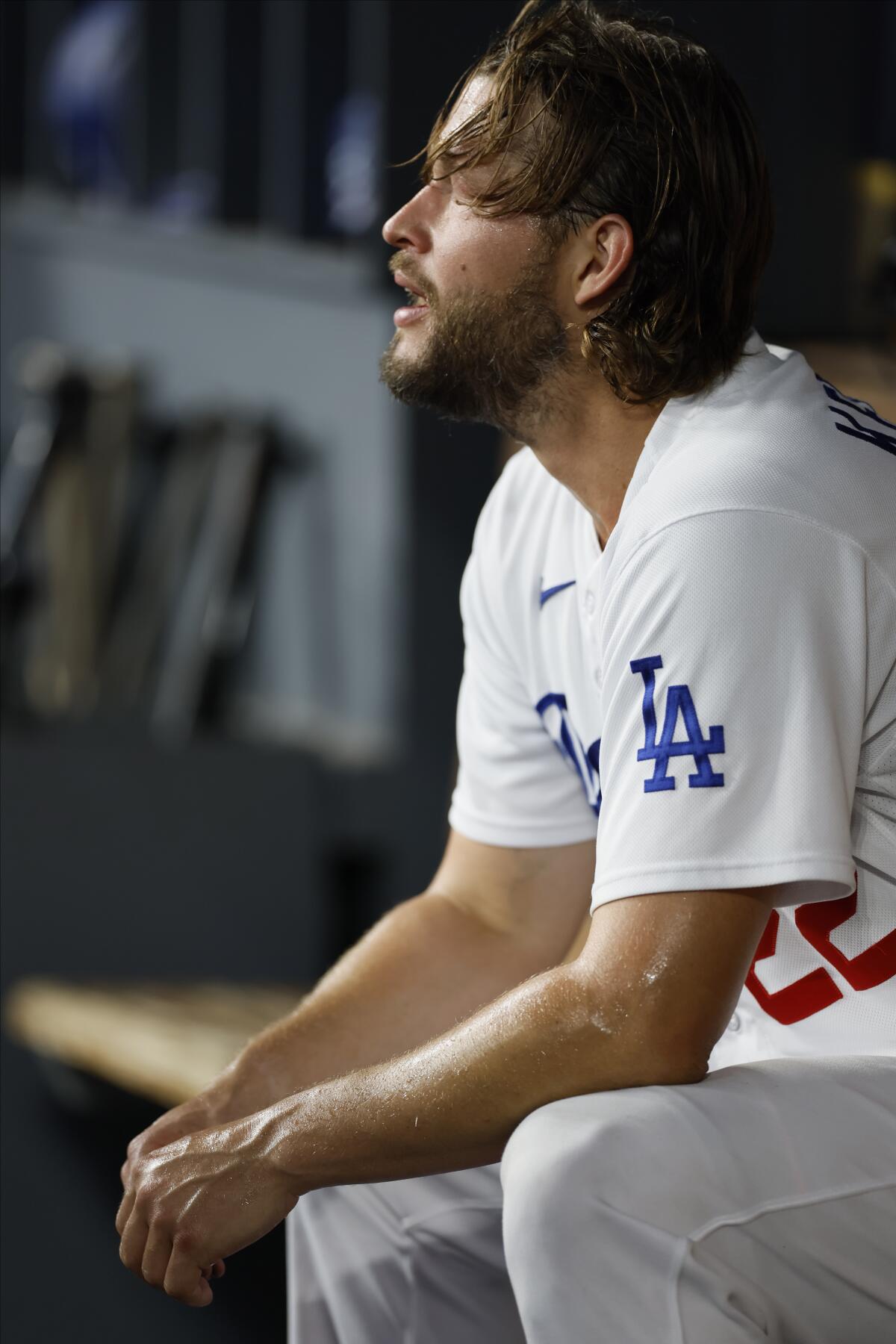 Clayton Kershaw sits in the dugout after being pulled in the first inning of Game 1 of the NLDS on Saturday.
