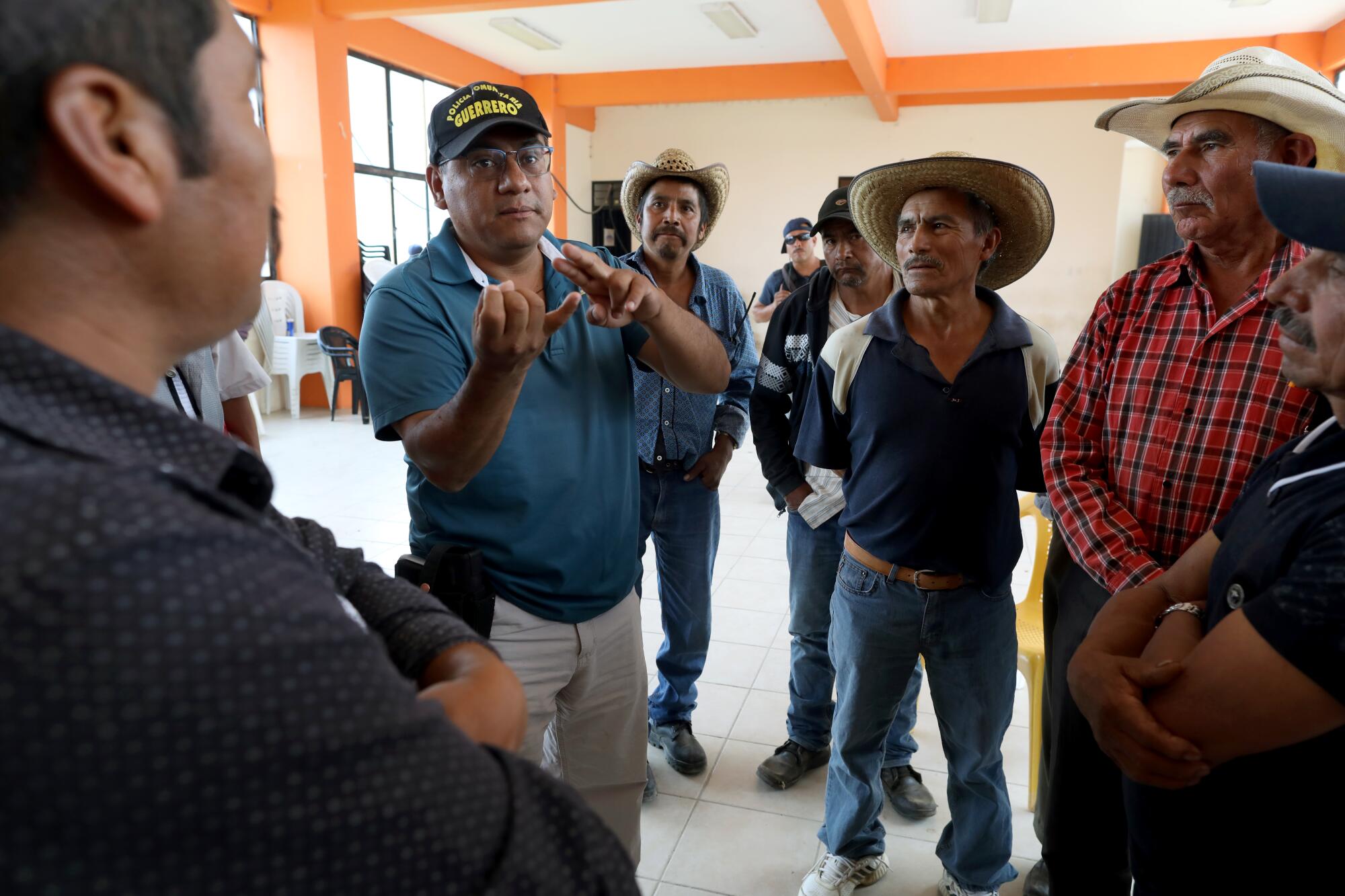 Salvador Alanís Trujillo, second from left, of the United Front of Community Police of Guerrero, meets with poppy farmers in Filo de Caballos. Farmers in Guerrero had been cultivating opium since the 1970s.