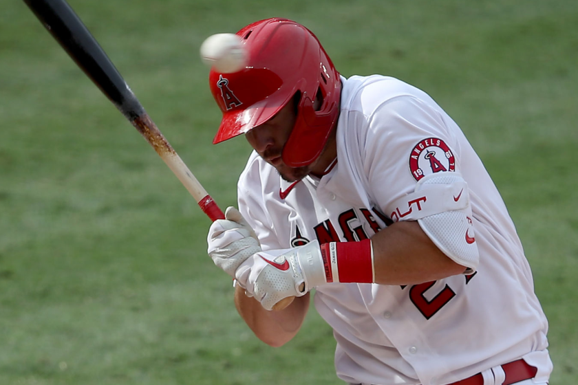 ANAHEIM, CALIFORNIA - AUGUST 18: Mike Trout #27 of the Los Angeles Angels ducks a high pitch.