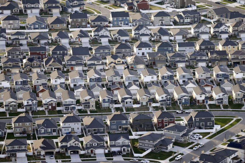 FILE - This April 13, 2019, file photo, shows rows of homes, in suburban Salt Lake City. Americans took out nearly $150 billion in loans backed by the Federal Housing Administration to buy homes in 2018. Nearly 83% of those FHA borrowers were first-time home buyers, according to the Department of Housing and Urban Development. (AP Photo/Rick Bowmer, File)