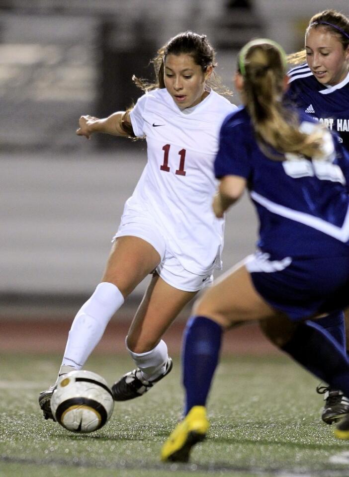 Estancia High's Alba Barrios (11) dribbles the ball during the first half against Newport Harbor in a nonleague game at Jim Scott Stadium on Thursday.