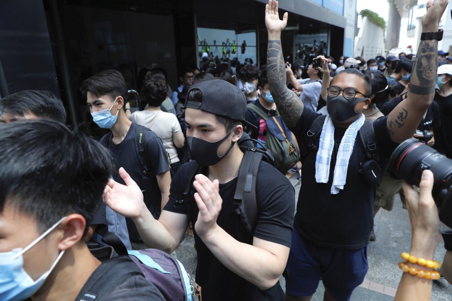Protesters march outside the Hong Kong Revenue Tower.