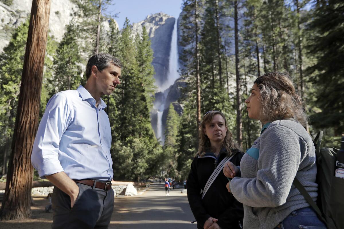 Democratic presidential candidate Beto O'Rourke, left, talks with Anne Kelly, center, Director of the Sierra Nevada Research Stations and environmental advocate Leslie Martinez in Yosemite National Park.