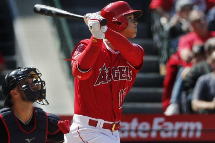 ANAHEIM, CA - APRIL 4, 2018: Los Angeles Angels designated hitter Shohei Ohtani (17) hits a 2-run homer to tie the game against the Cleveland Indians in the fifth inning on April 4, 2018 at Angel Stadium in Anaheim, California. (Gina Ferazzi/Los AngelesTimes)