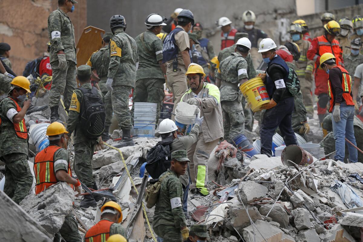 Search and rescue teams remove rubble at a collapsed six-story residential building in Mexico City.