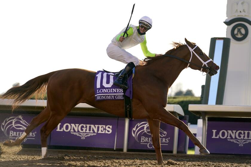Florent Geroux rides Monomoy Girl to win the Breeders' Cup Distaff horse race at Keeneland Race Course.
