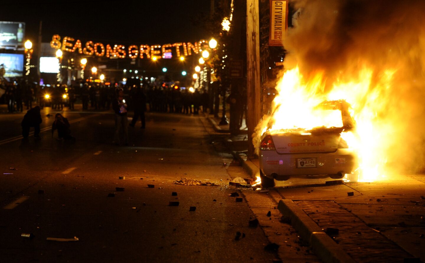 A St. Louis County police car burns during demonstrations in Ferguson, Mo., after the grand jury's decision was announced.