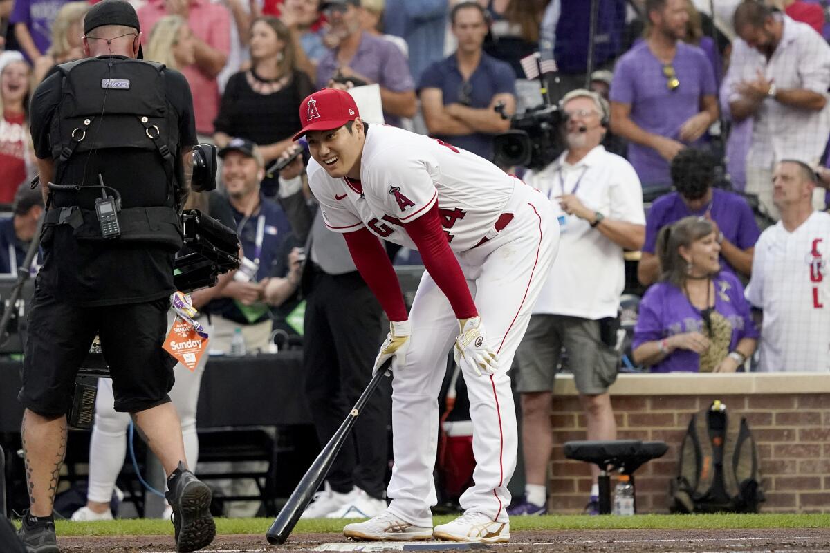 The Angels' Shohei Ohtani rests after hitting during the first round of the home run derby July 12, 2021.