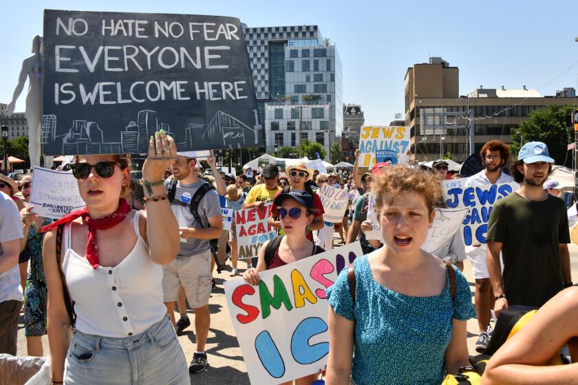 Diana Goldsmith, left, and Judy Sweet, right, both of Baltimore City, march with more than 100 protesters from Baltimore Jews Against ICE and Jews United for Justice at Artscape. They were protesting the involvement with ICE by two Artscape sponsors, Johns Hopkins University, and PNC Bank, through contracts and financing.