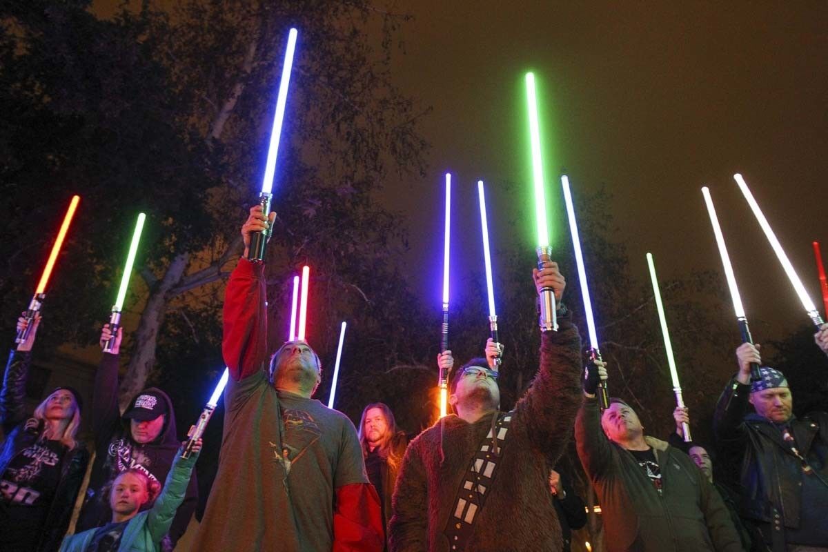 ESCONDIDO, December 30, 2016 | Around fifty Star Wars fans raise their lightsabers in tribute to actress Carrie Fisher, who played Princess Leia in the movie, at the California Center for the Arts in Escondido on Friday. | Photo by Hayne Palmour IV/San Diego Union-Tribune/Mandatory Credit: HAYNE PALMOUR IV/SAN DIEGO UNION-TRIBUNE/ZUMA PRESS San Diego Union-Tribune Photo by Hayne Palmour IV copyright 2016