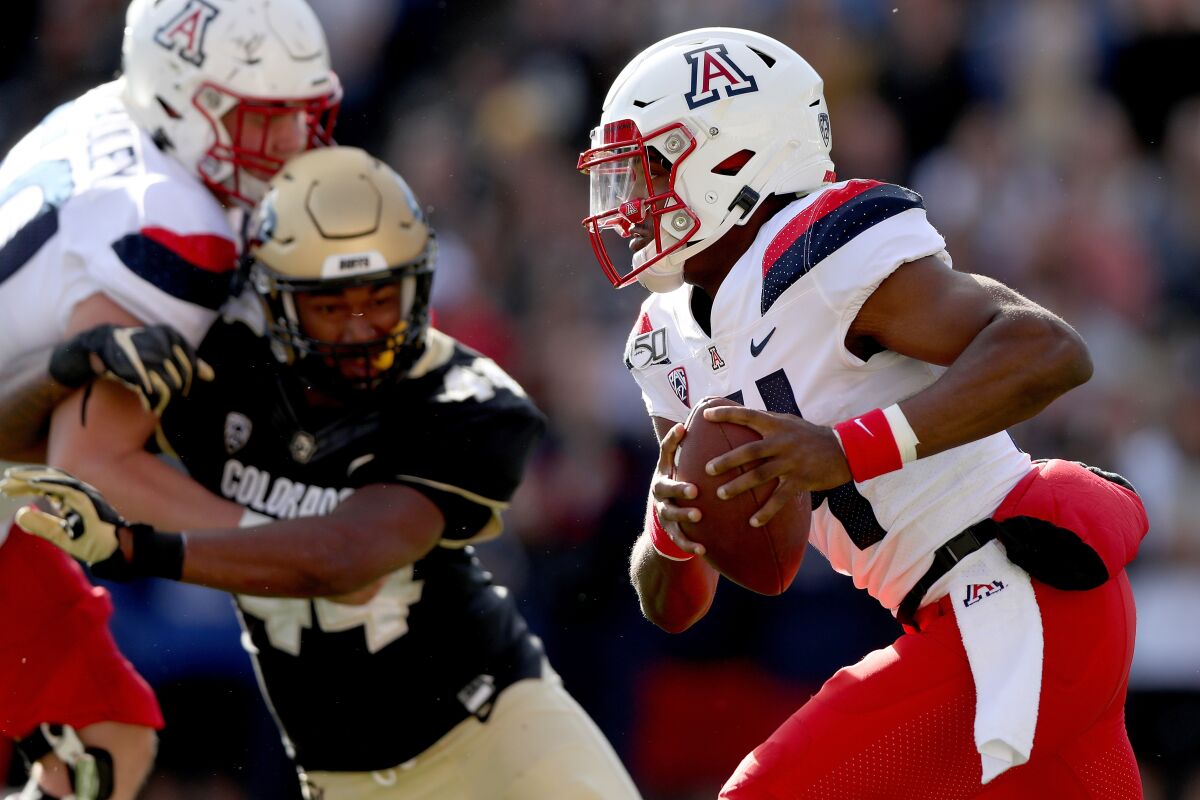 Arizona quarterback Khalil Tate carries the ball against Colorado in the second quarter Saturday in Boulder, Colo.