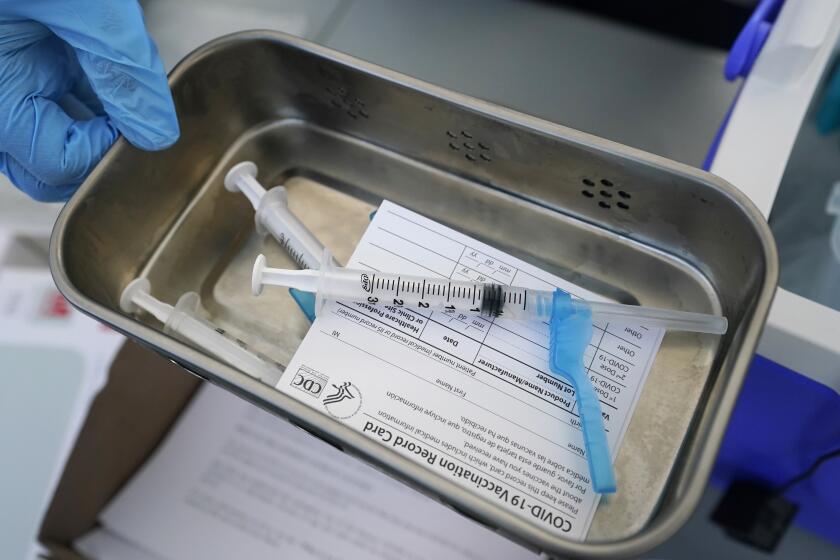 FILE - This Thursday, May 13, 2021 file photo shows syringes filled with the Johnson & Johnson vaccine at a mobile vaccination site in Miami. A news conference by doctors in Palm Beach Gardens, Fla., on Monday, Aug. 23, 2021, to urge the public to get vaccinated as COVID-19 infections surge in the state was undermined online as false reports claimed the physicians had walked off the job. (AP Photo/Wilfredo Lee, File)