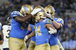 UCLA running back Zach Charbonnet, center, celebrates his touchdown with teammates during the second half of an NCAA college football game against California Saturday, Nov. 27, 2021, in Pasadena, Calif. UCLA won 42-14. (AP Photo/Jae C. Hong)